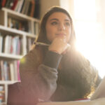 a student studying and smiling